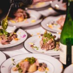 Shows an elegant entree being plated by The Painted Table chefs