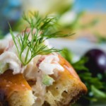 Close-up of a lobster roll garnished with fresh dill
