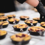 Chef preparing peach cobbler dessert for an event