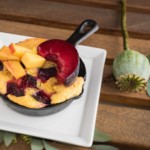Peach cobbler dessert served in a mini cast iron skillet