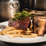 Steak frites with bone marrow served at a Paris themed dinner