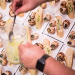 Chef preparing multiple plates of escargot for event service