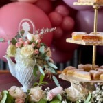 Floral arrangement displayed in an elegant teapot centerpiece