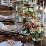 Styled high tea tablescape featuring finger sandwiches and floral accents